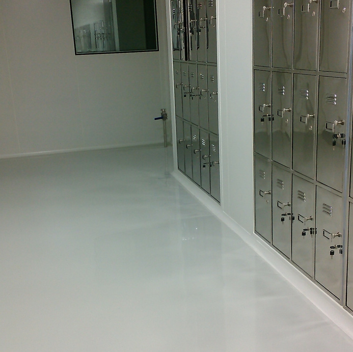 Hygienic coated walls and floor beside stainless steel lockers